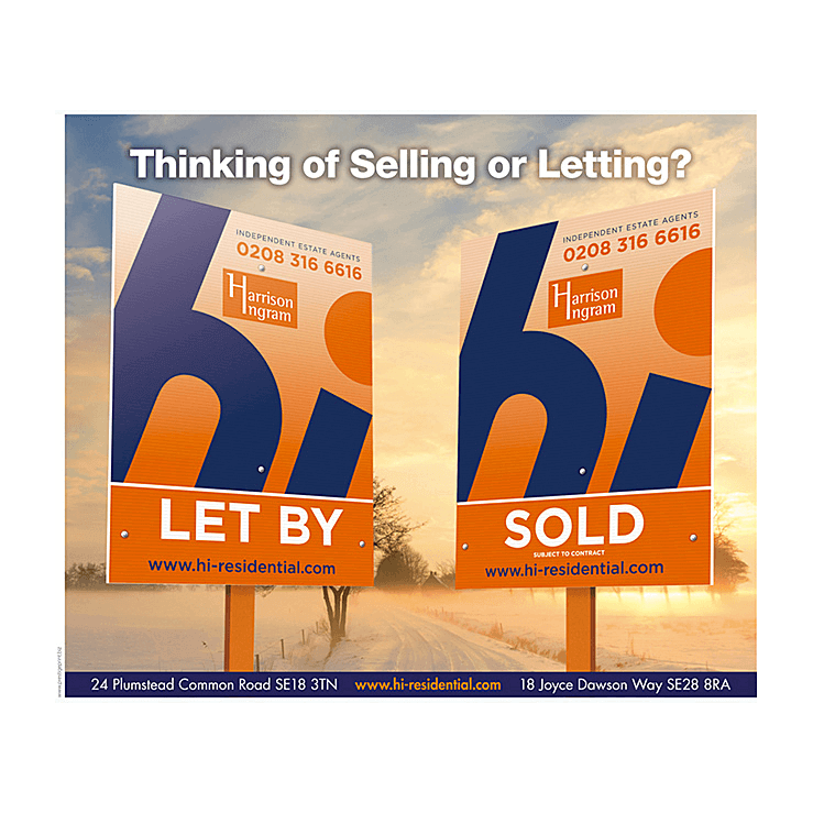 Estate agents boards on a winter scene