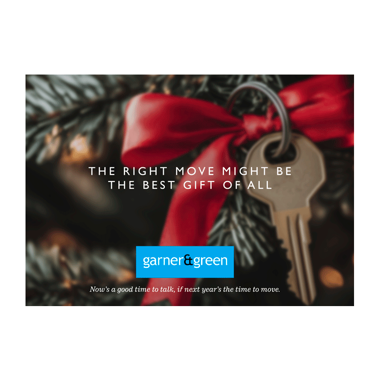 Close-up of a house key tied with a red ribbon on a festive tree