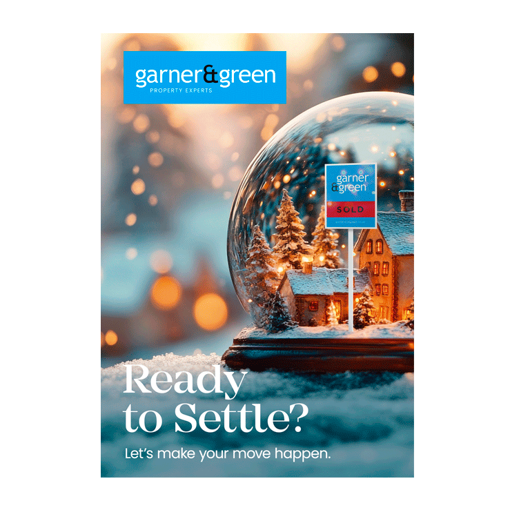 Snow globe with SOLD board under festive lights